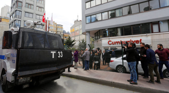 An armored police vehicle drives past by the headquarters of Cumhuriyet newspaper, an opposition secularist daily, in Istanbul