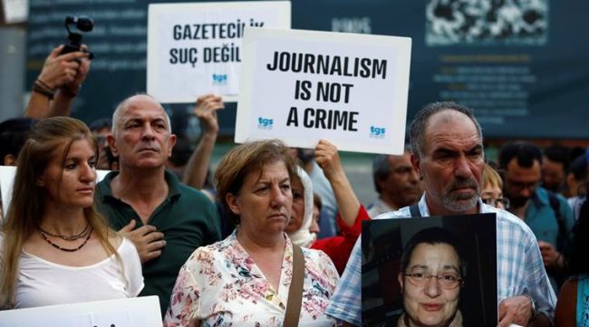 Demonstrators shout slogans during a protest against the arrest of three prominent activists for press freedom, in central Istanbul